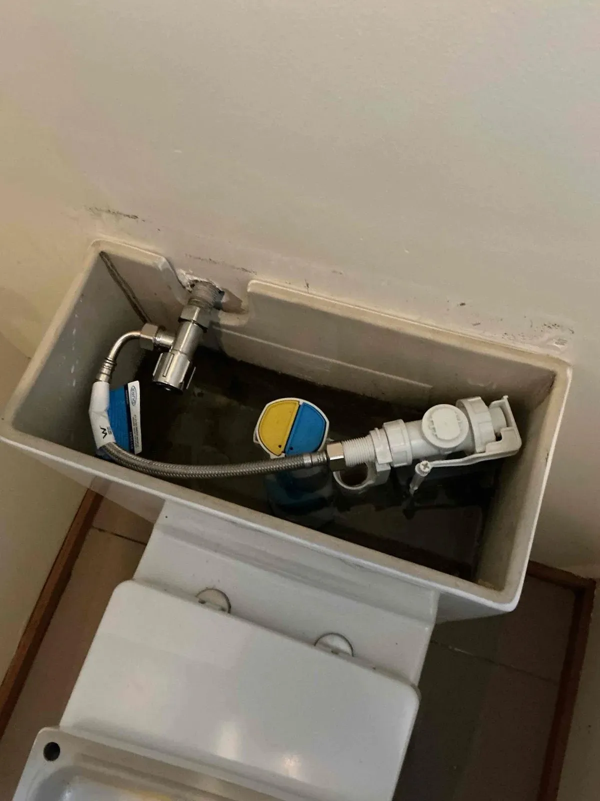 Toilet cistern open showing the new internal parts