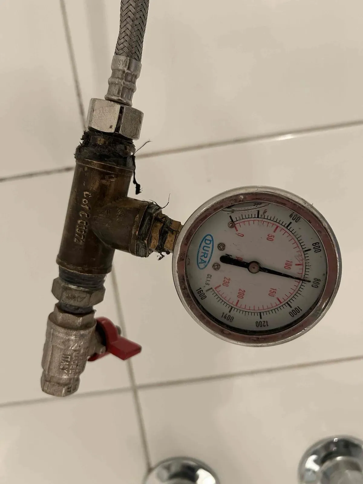 Pressure gauge testing the shower pipework