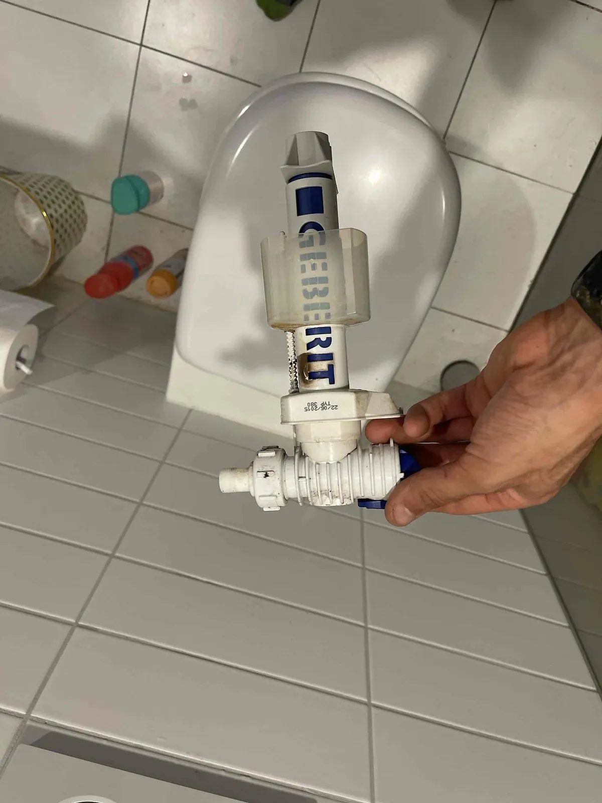 Faulty toilet inlet valve removed from the cistern