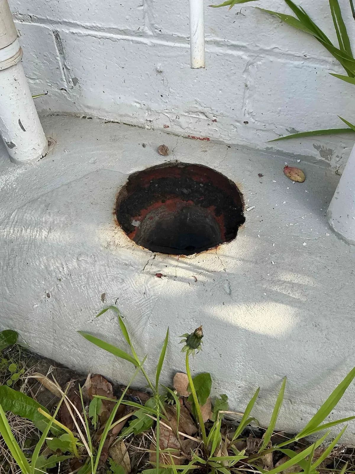 Cleared drain opening on a concrete surround