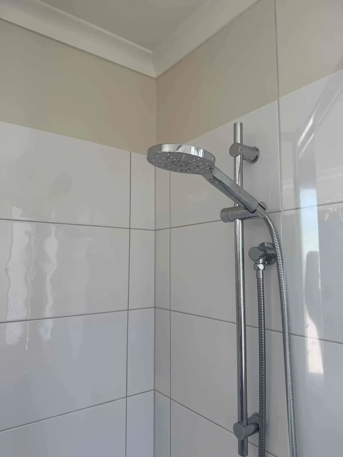 Shower rail and head in a tiled shower