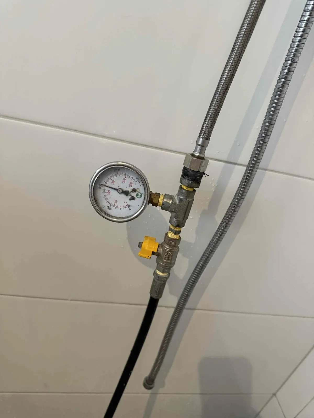Pressure gauge testing the bathroom water pipes