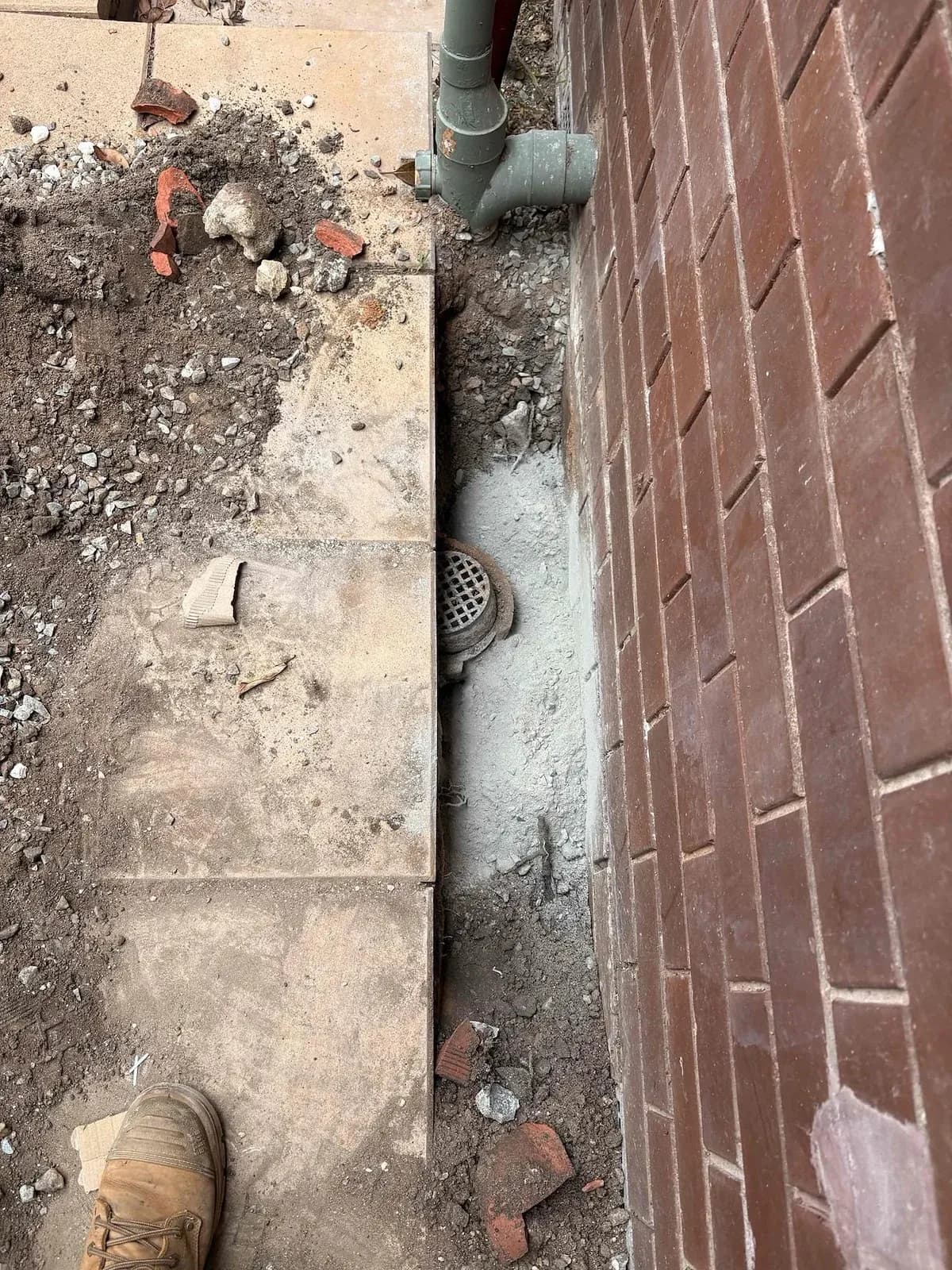 Paving lifted to dig down to a blocked shower drain in Mount Waverley