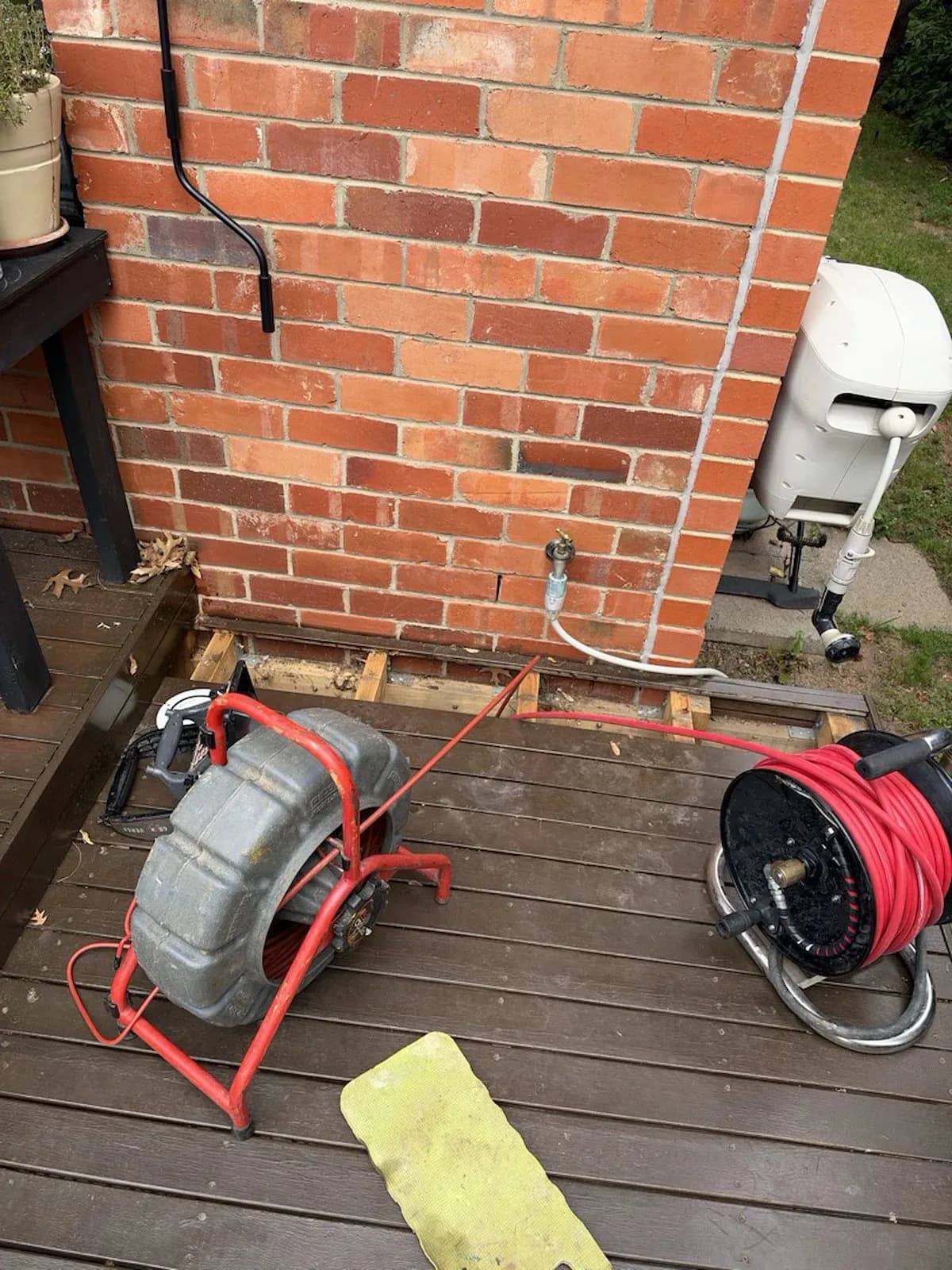 Drain cleaning machine set up beside the house