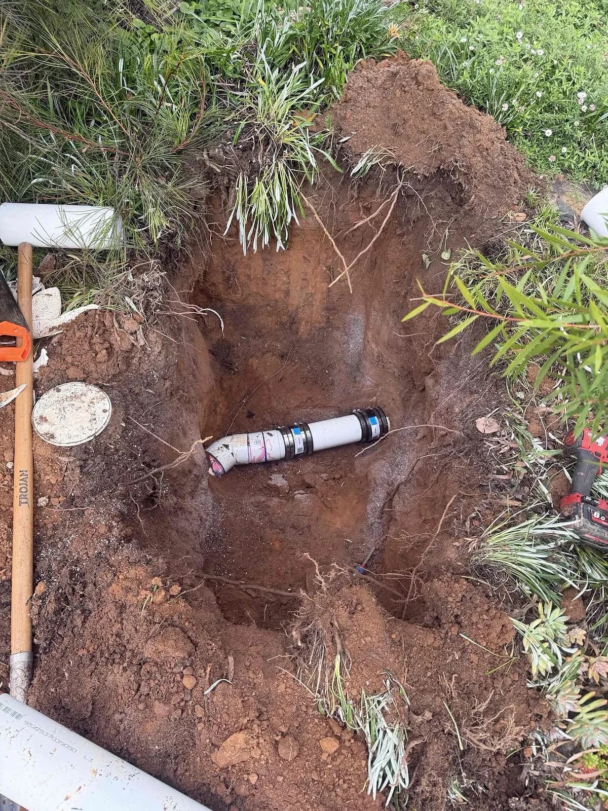 Excavated drain with the pipe exposed