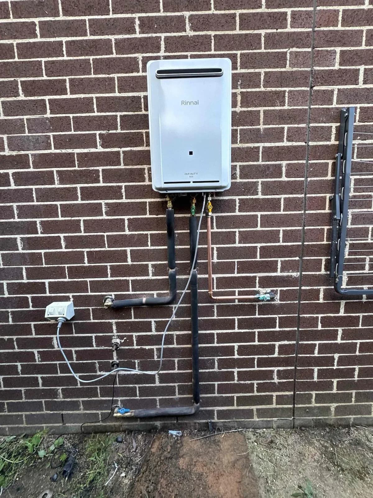 New continuous flow hot water unit mounted on the same brick wall