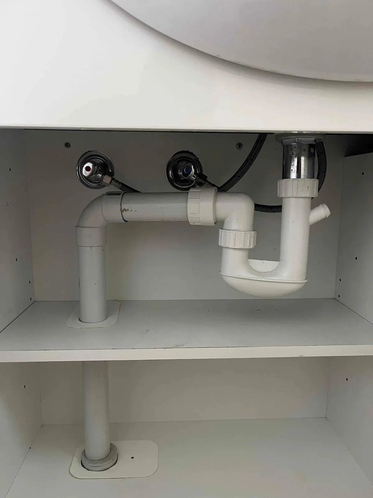New sink trap and pipework under a basin