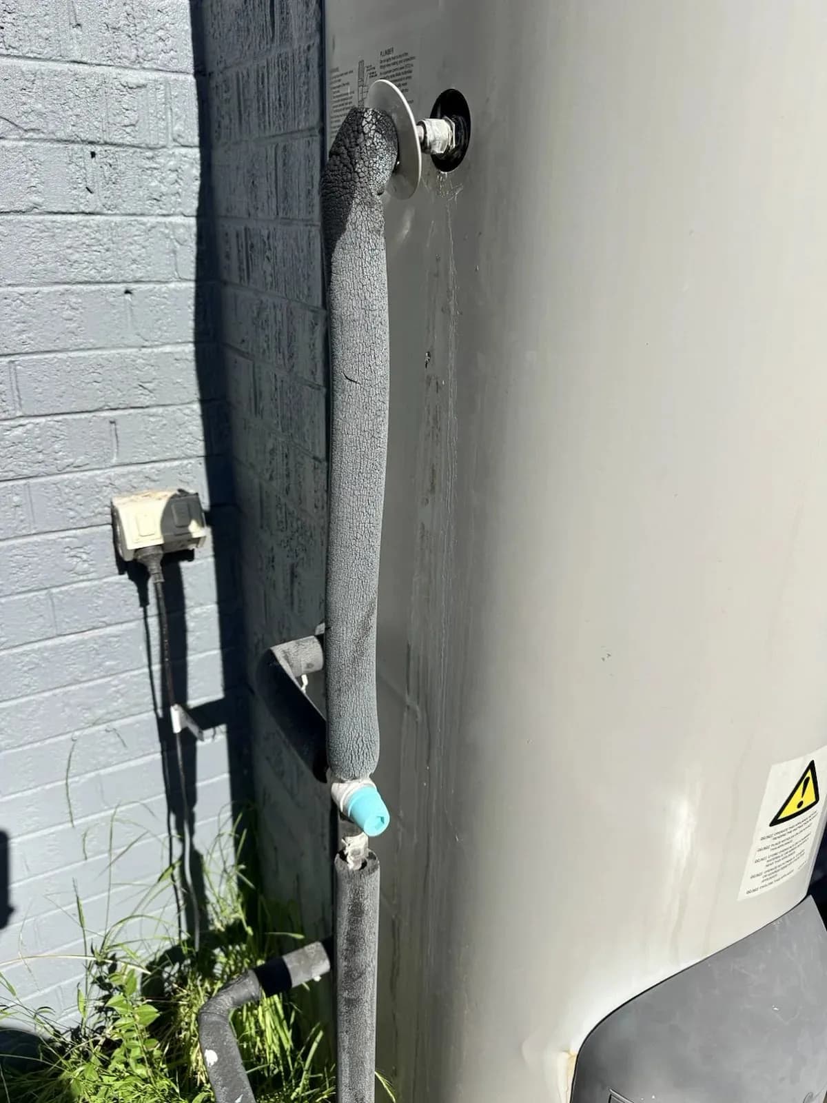 New valve and drain line fitted on the hot water unit