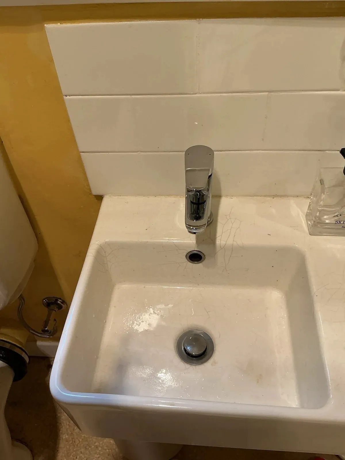 Bathroom basin and mixer tap in an older apartment
