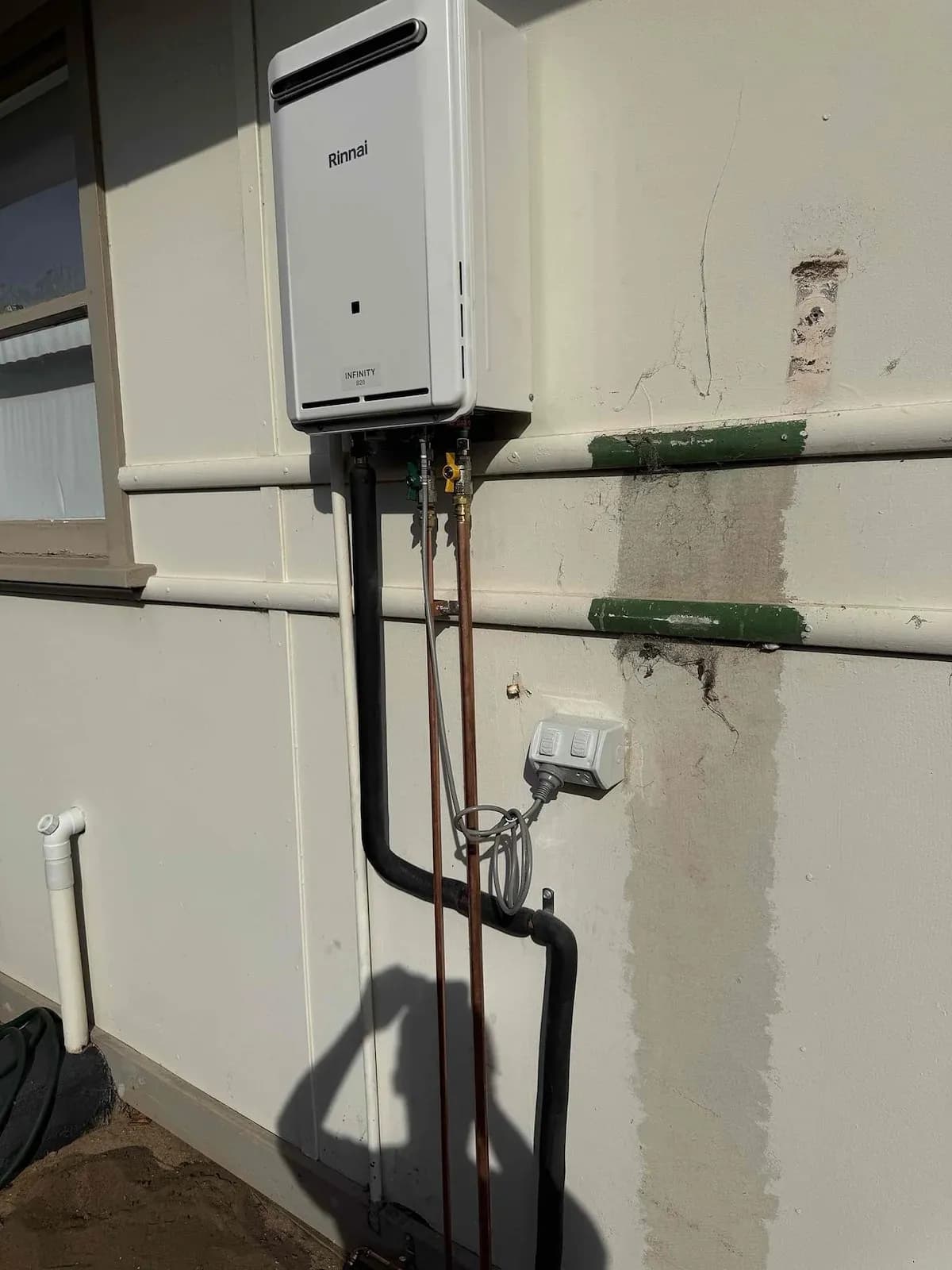 New continuous flow hot water system on the wall
