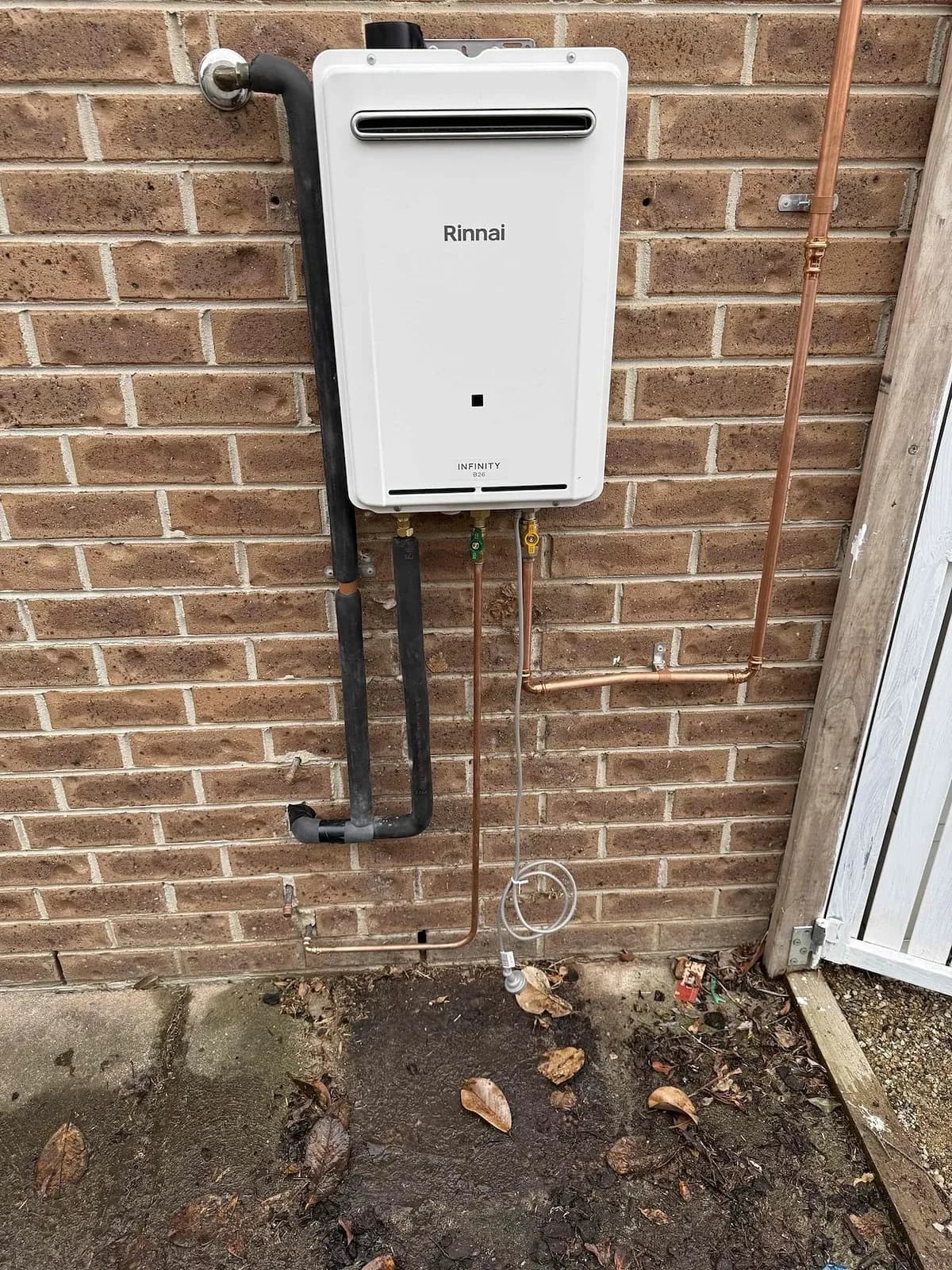 New continuous flow hot water unit on a brick wall