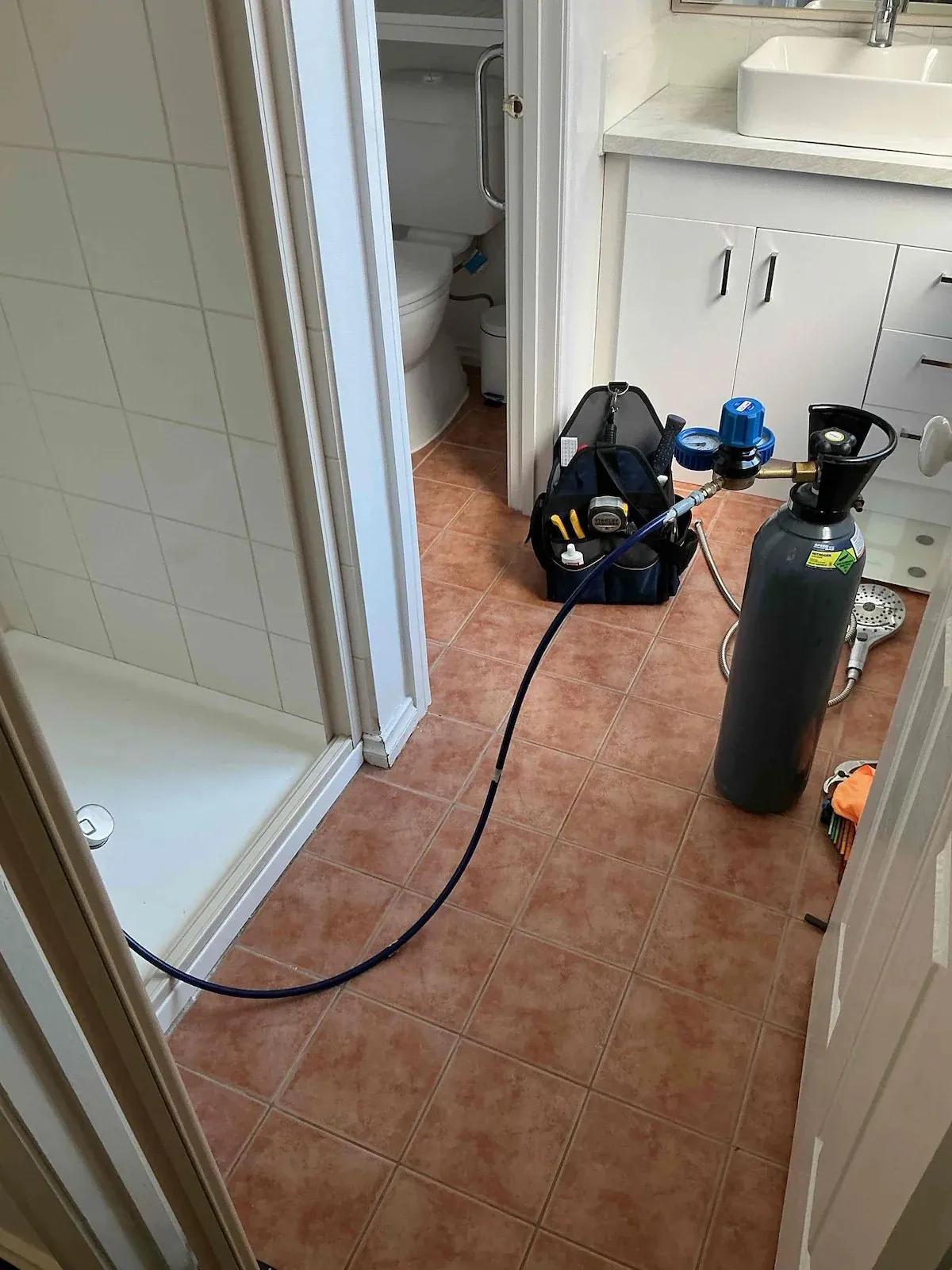 Leak detection gear set up outside the shower