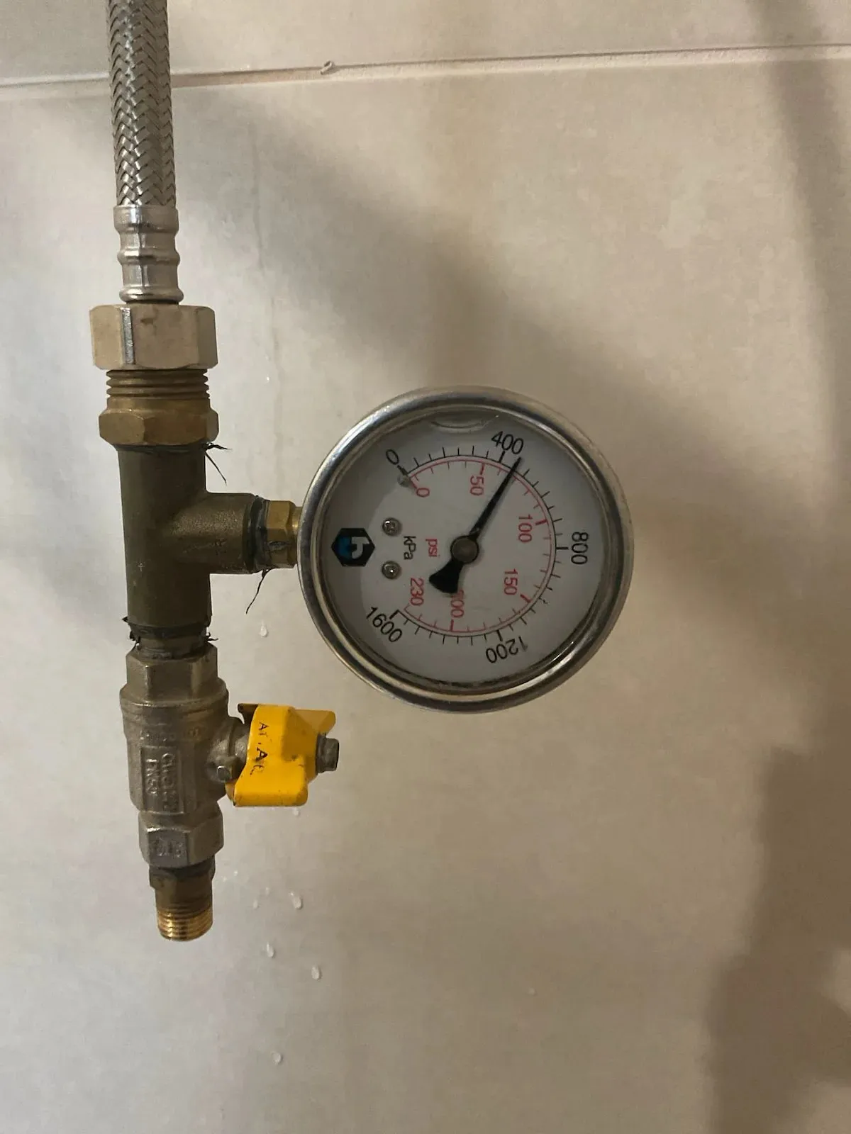 Pressure gauge testing the shower water supply