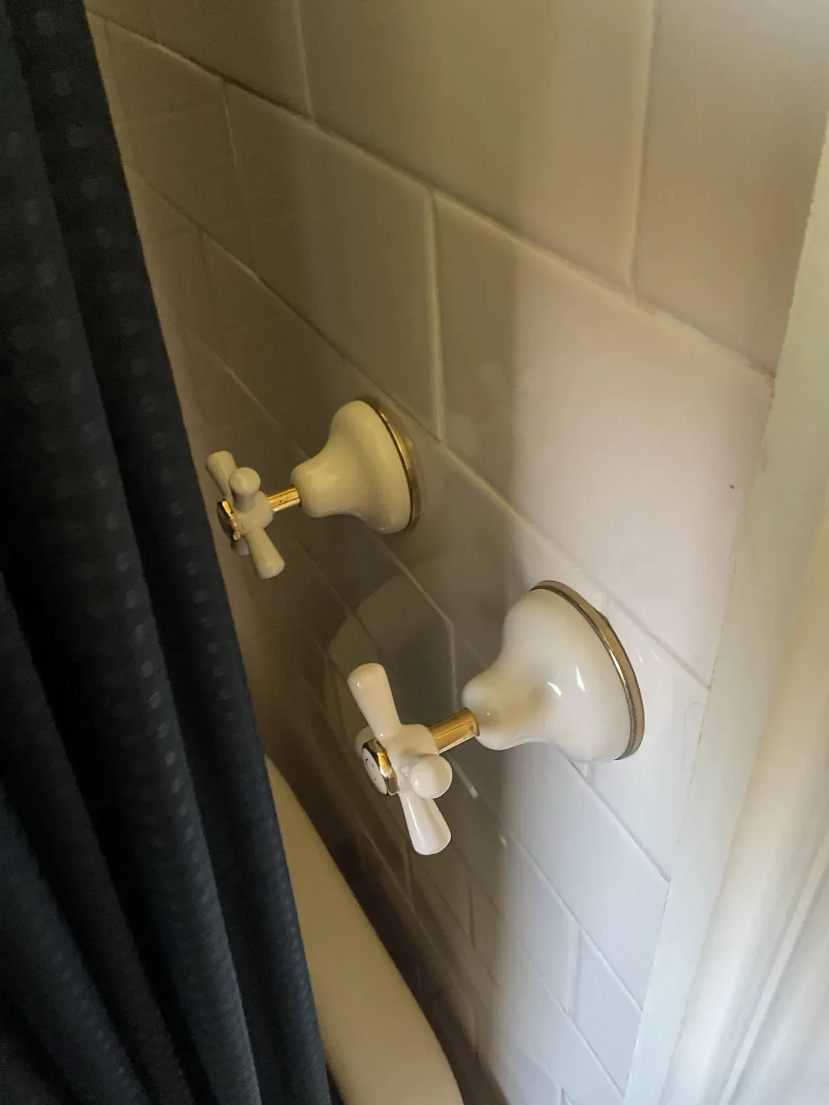 Shower taps on a tiled wall
