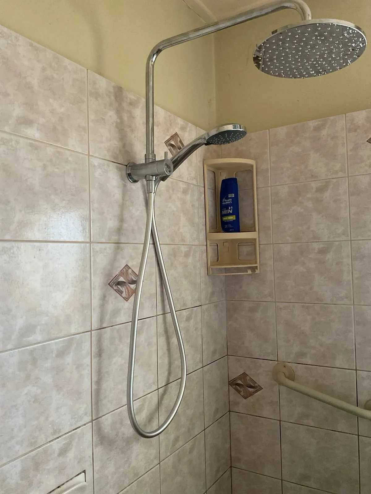 New rail shower fitted in a tiled bathroom