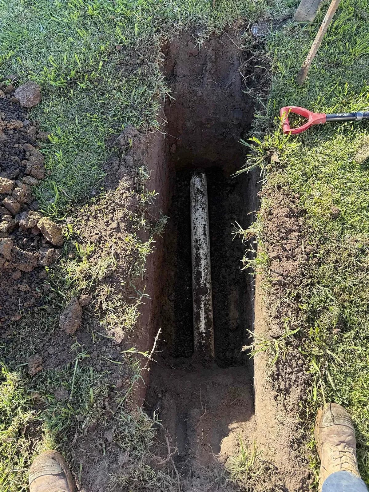 Main drain exposed in a trench for the patch reline