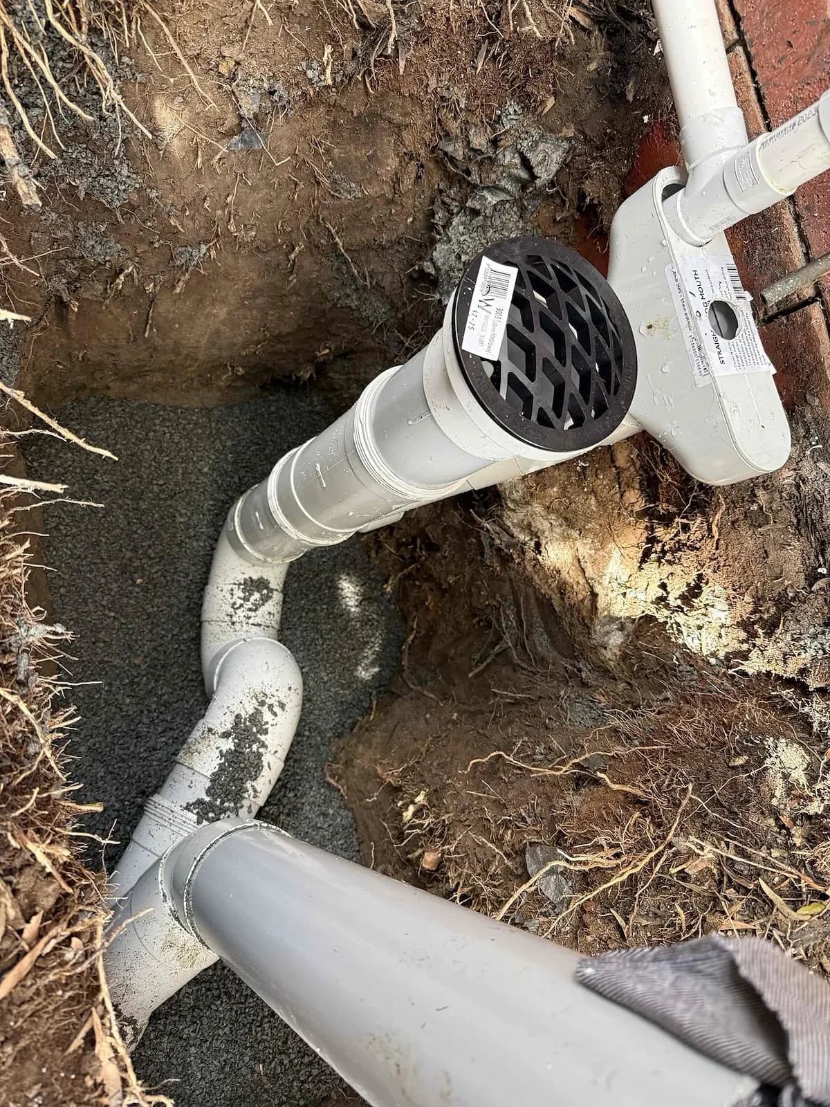 New pipework and grate beside the house