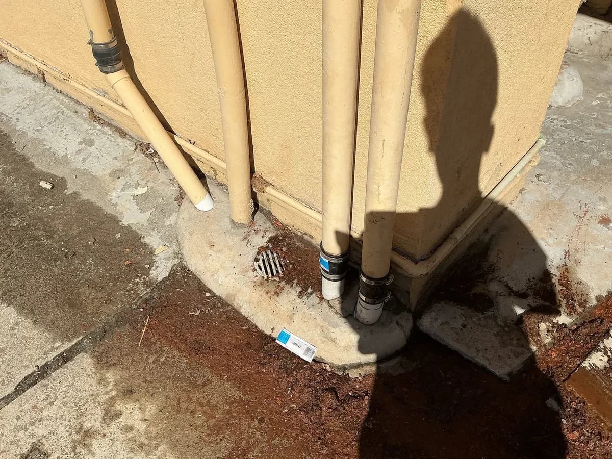Overflowing drain at the base of the building