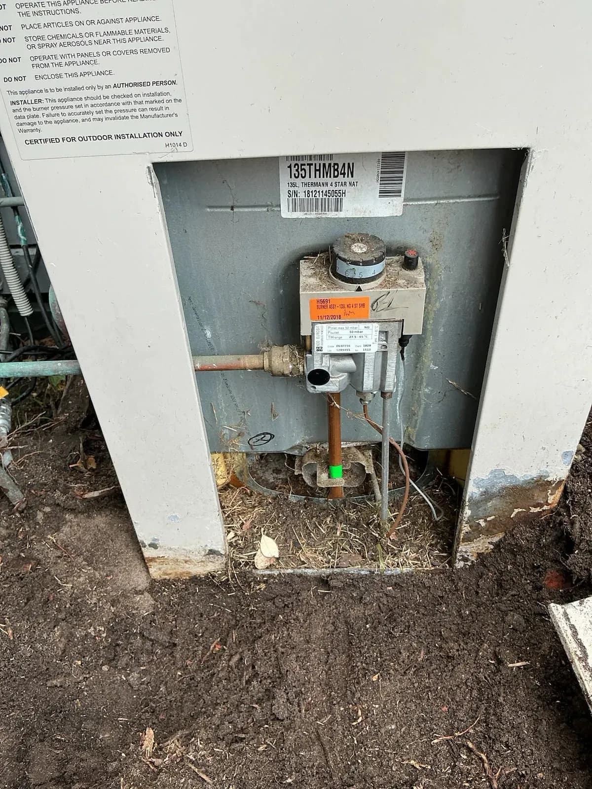 Old gas hot water unit with its gas control exposed