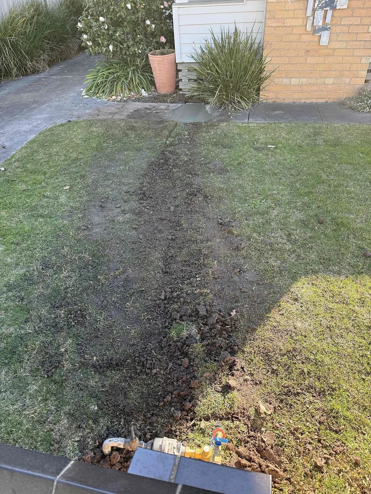 Trench across the front lawn for the new water line