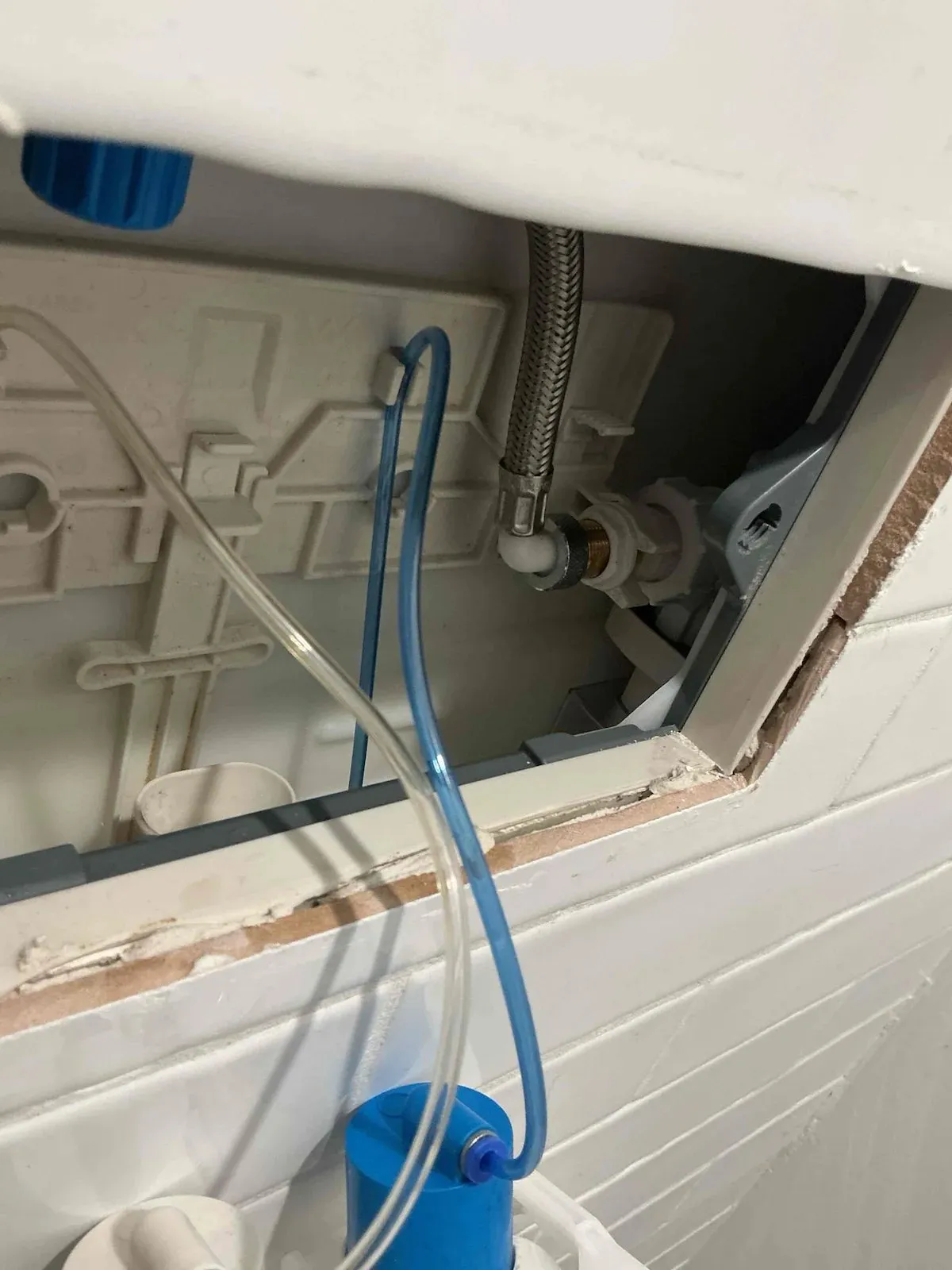 In-wall cistern opened up to fit the new valve