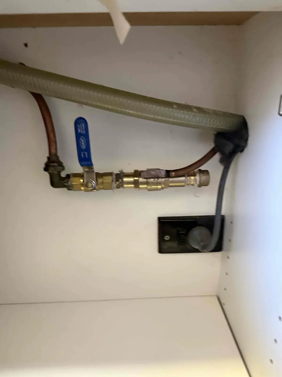 Old valve under the sink before the replacement