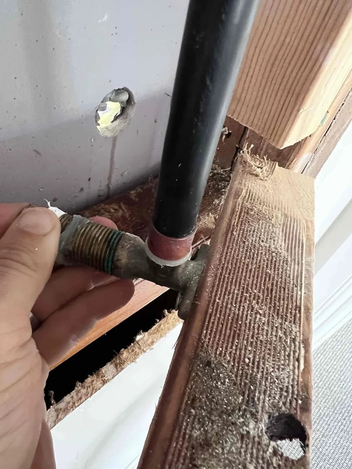Leaking pipe fitting found in the wall