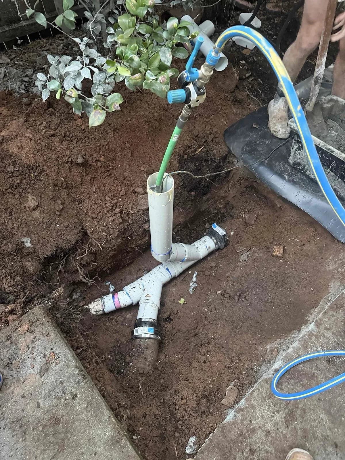 New PVC sewer junction and riser in the excavation