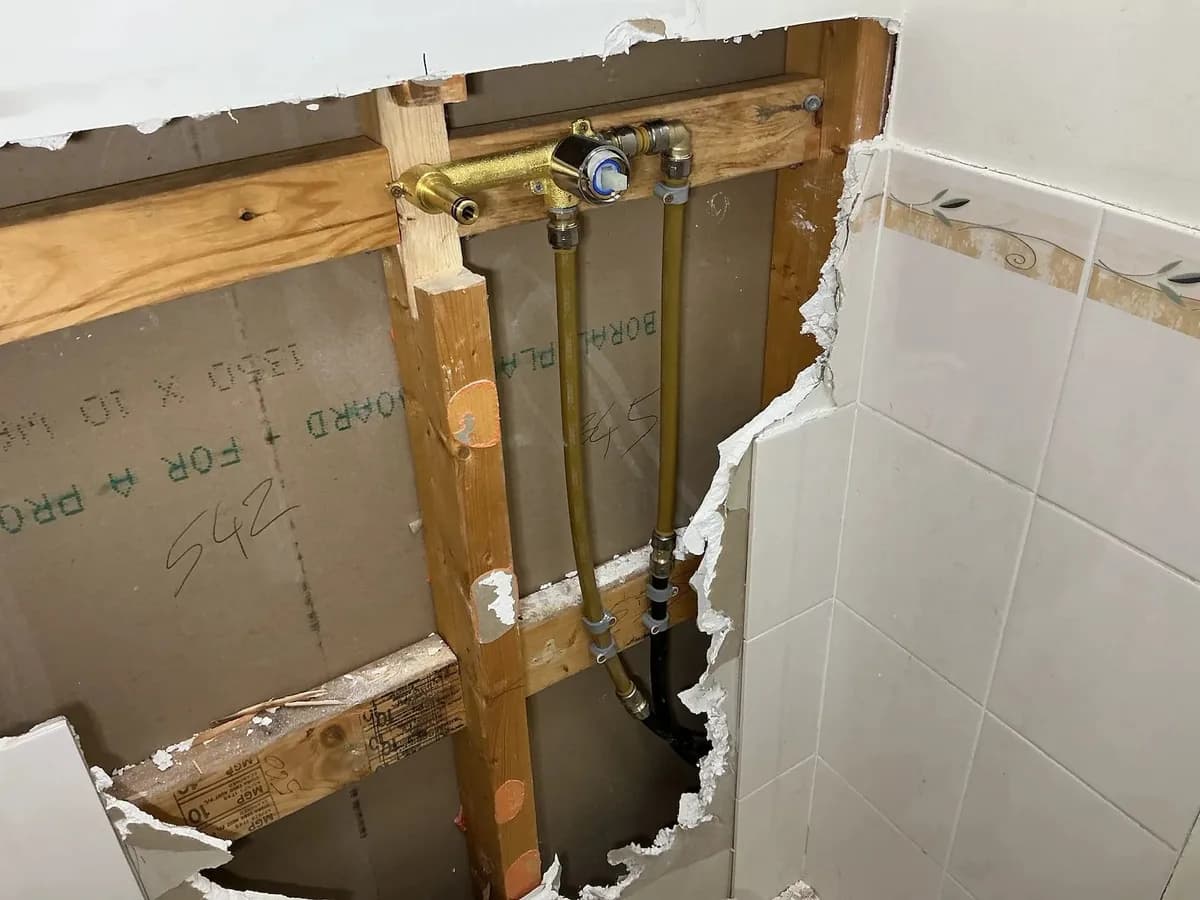 Wall opened up where the old lines were capped off for the renovation