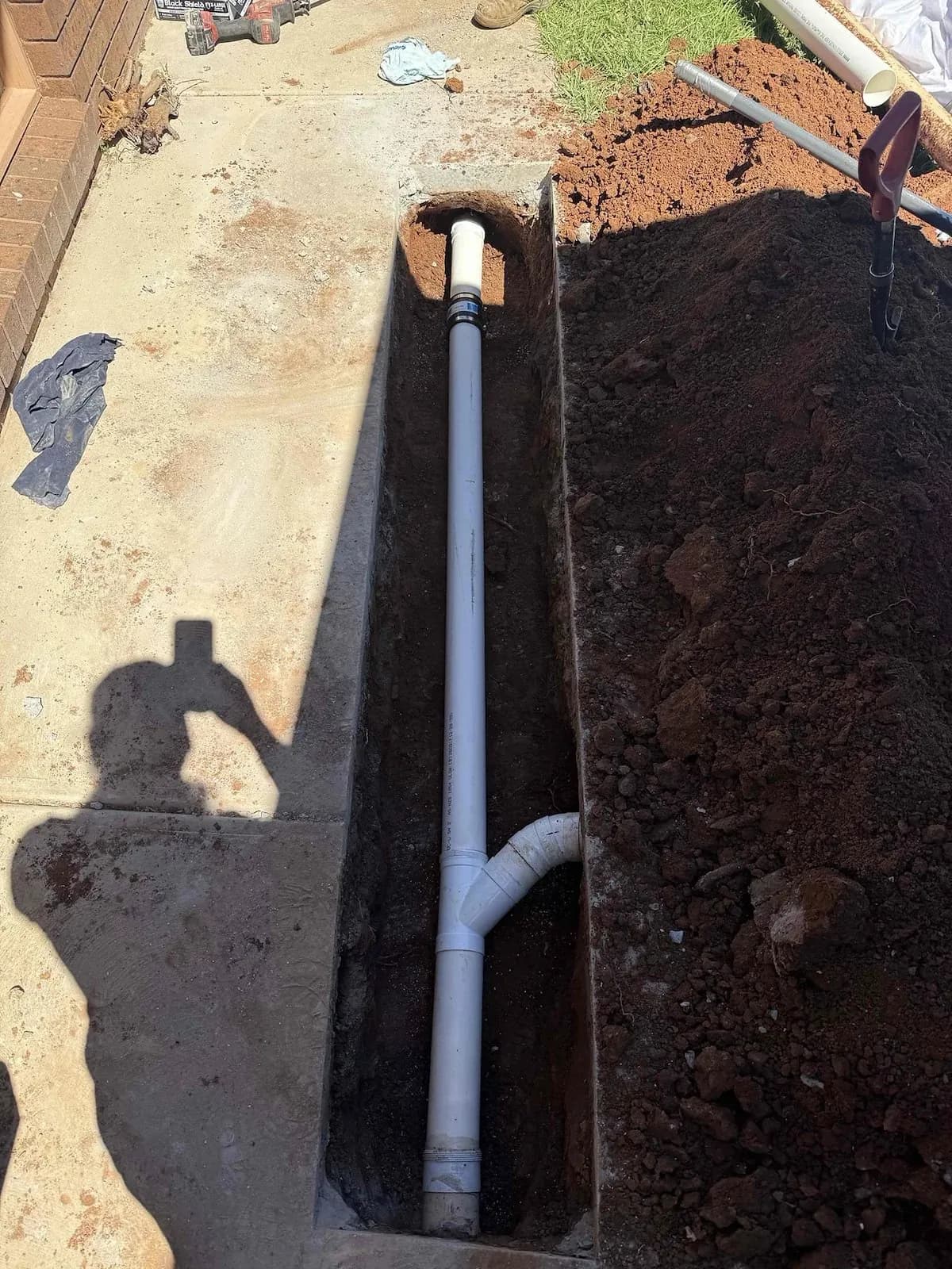 New stormwater pipe section laid beside the garage