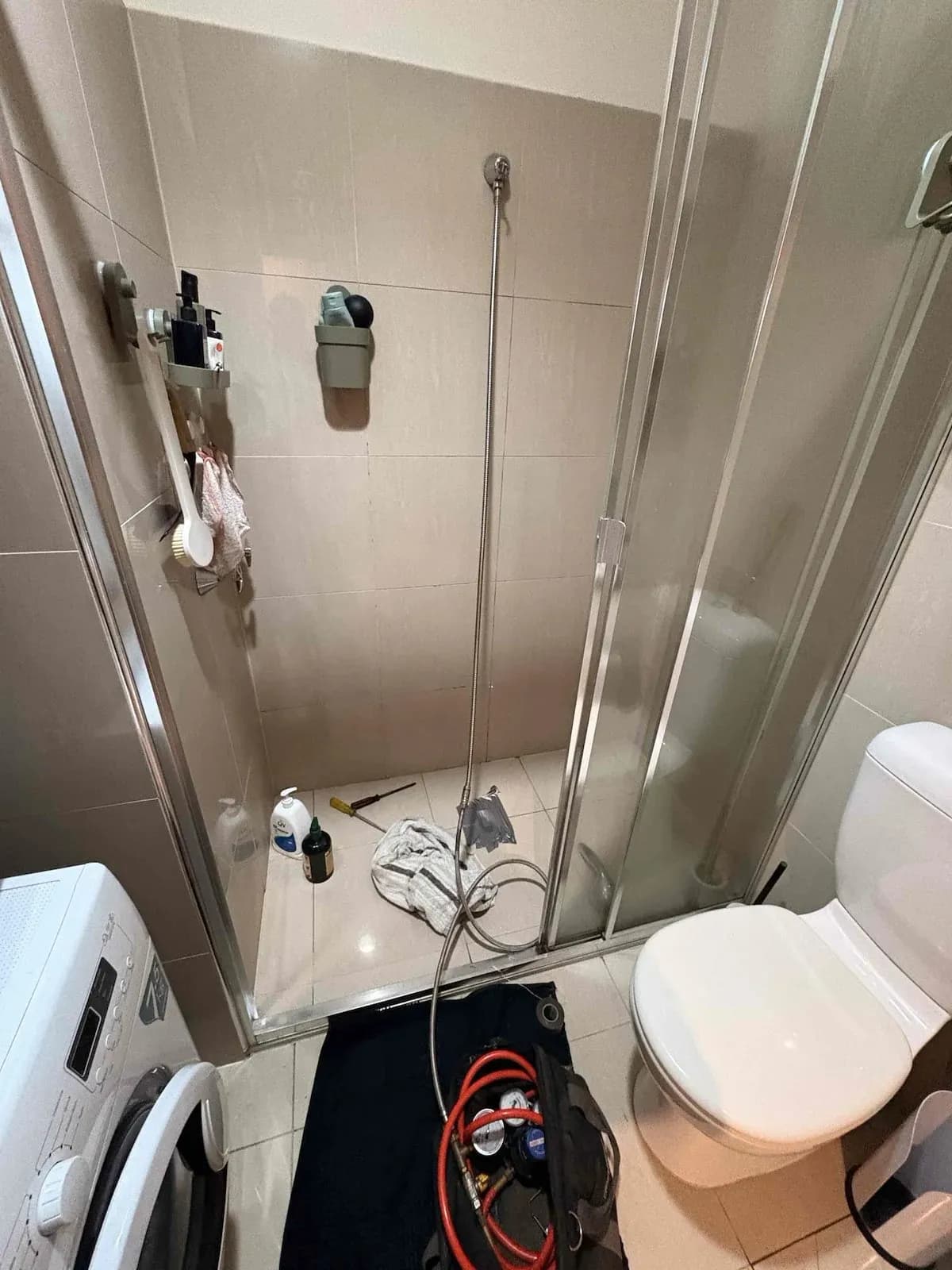 Shower set up for leak testing with gear on the floor