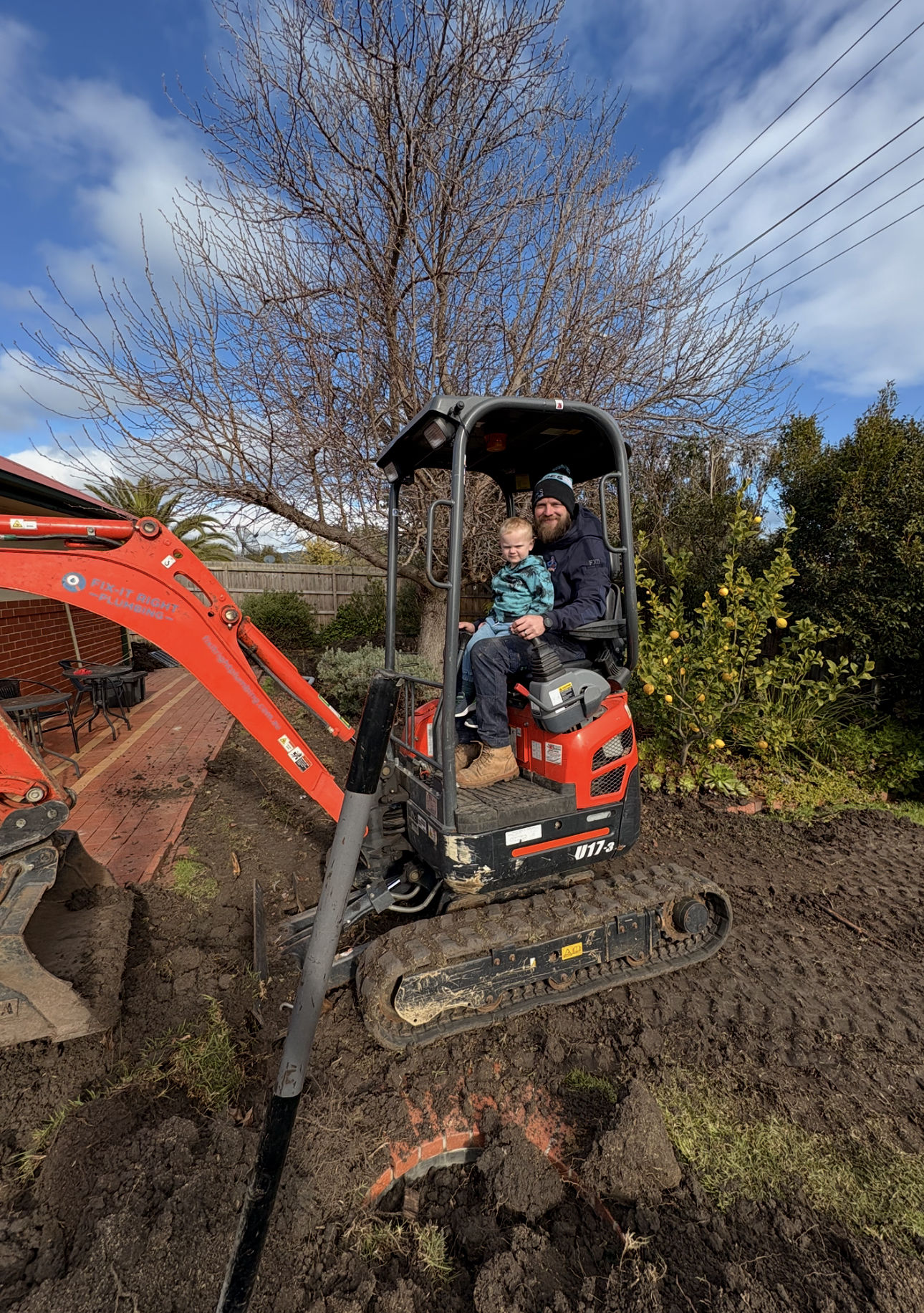 Fix-It Right Plumbing plumber with his son on a digger