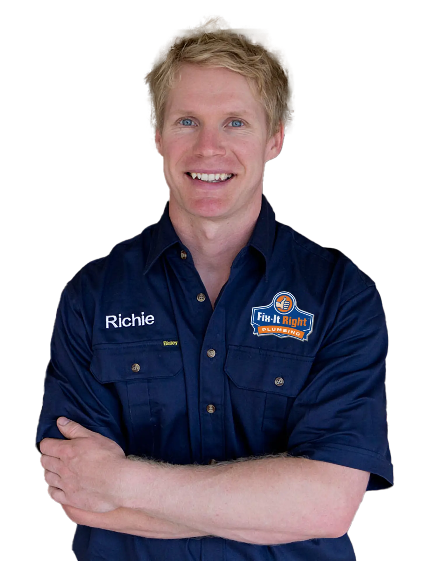 Plumber wearing a navy blue Fix-It Right Plumbing uniform, with the Fix-It Right Plumbing logo, with the name Richie embroidered on it, standing with arms crossed.