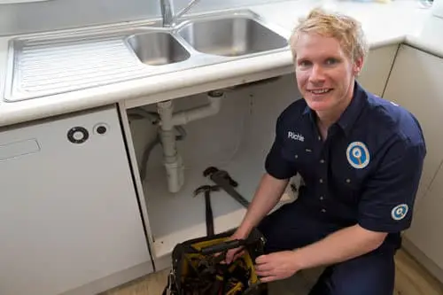 Plumber Richie next to a sink