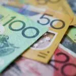 Australian banknotes including $100, $50, and $20 notes spread out, symbolizing transparent pricing and plumbing service costs from Fix-It Right Plumbing