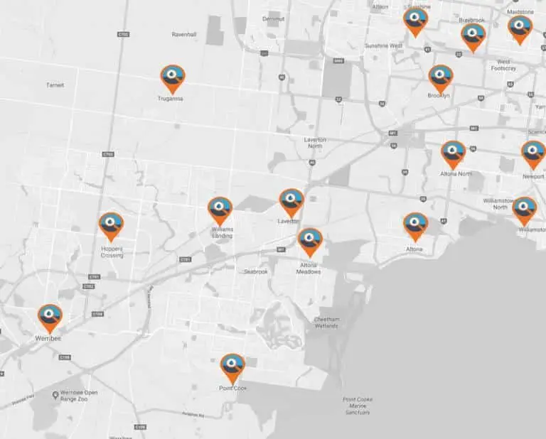 A grayscale map showing various locations marked with orange and blue map pins across urban and Western Suburbs areas, highlighting plumber service points.