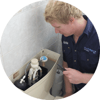 plumber fixing toilet